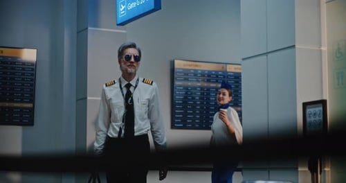Airline Pilot and Two Flight Attendants Passing International Airport Terminal