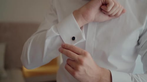 Man Attaching Cufflinks on White Shirt Sleeve