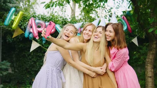 Smiling Women Take Selfie at Birthday Party