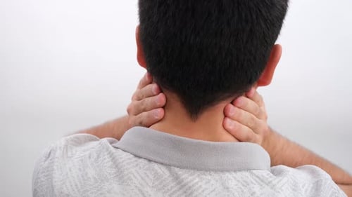 Man Massaging his Neck for Soreness