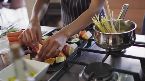 Video of hands of biracial woman preparing meal