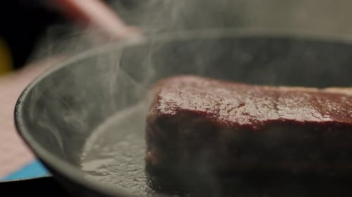 Beef Steak Roasting on Frying Pan Close Up