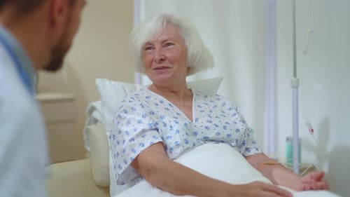 In the Private Hospital Office Old Caucasian Positive Woman Communicating with Profesisonal Doctor