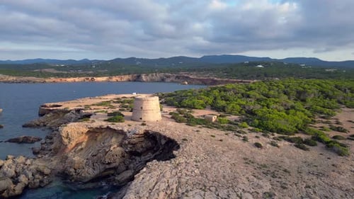 mediterranean coastal sunset ancient historic tower. Best aerial top view flight circle drone footag