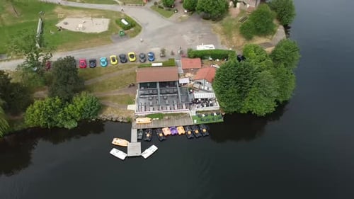 Aerial video over green countryside with lake in Cublize