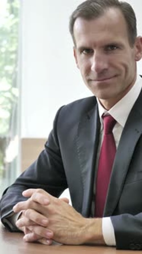 Professional Man in Suit Gives Thumbs Up Indoors