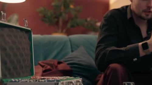 Man Contemplating Game with Poker Chips in Case