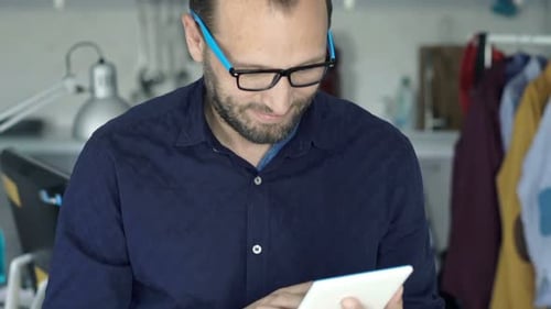 Man Using Tablet at Desk in Home