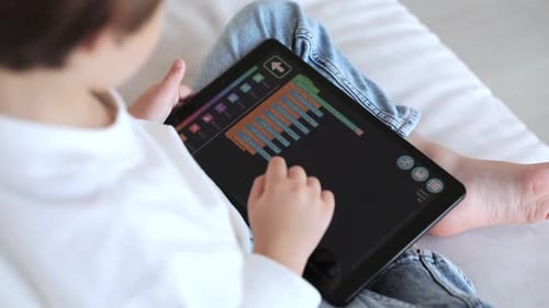 A Preschool Kid Programmer Coding at Tablet Pc Uses Machine Language