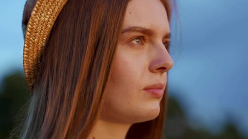 Woman with Long Brown Hair Wearing a Straw Hat