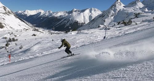 Action alpine skiing with male skiing athlete. Beautiful short ski turns in wonderful mountain lands