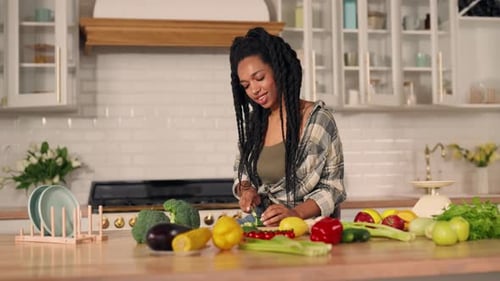 Young Woman Prepares Vegetables in Kitchen