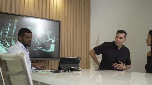 Doctor Explains Spine X-Ray to Patient in Office