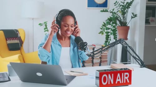 Young Smiling African American Woman Business Coach Sits at Desk in Home Office