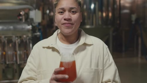 Young Adult Drinks Beer at Brewery