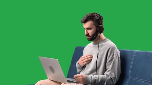 Man Talking Online Video Call Use Laptop Remotely Meetup on Couch Isolated Green Screen Chroma Key