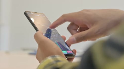 Close up of African Man Trading on Smartphone, Financial Graph