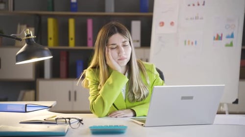 Businesswoman falling asleep at night.