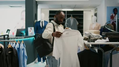Retail Customer Examining New Shirts Collection