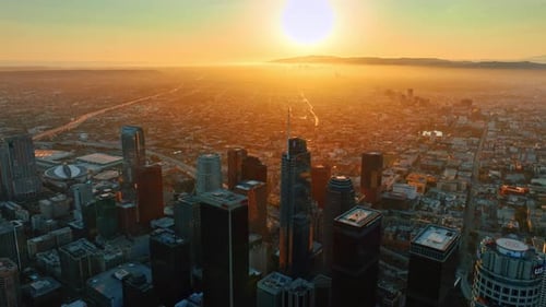 Stunning orange light of setting sun covering the panorama of Los Angeles, California, USA.