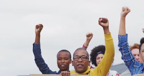 Diverse Group Protesting Raising Fists with Signs