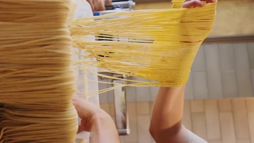 Italian Pasta Being Made on the Machine for Cutting Dough Fresh Handmade Pasta Machine Rolling Dough