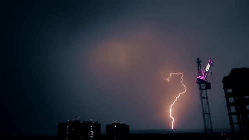 Bright Flashes of Lightning Sparkle Over the Night City