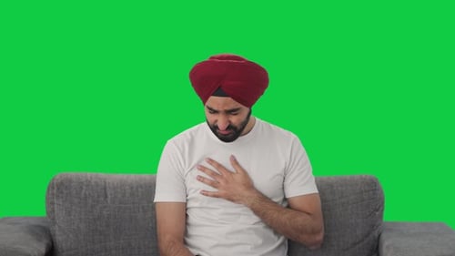 Sick Sikh Indian man suffering from cold and cough Green screen