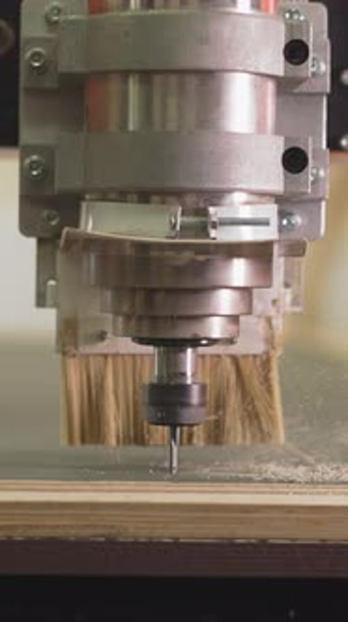 Wood Lathe Machine Cuts Out Line in Plywood Sheet in Shop