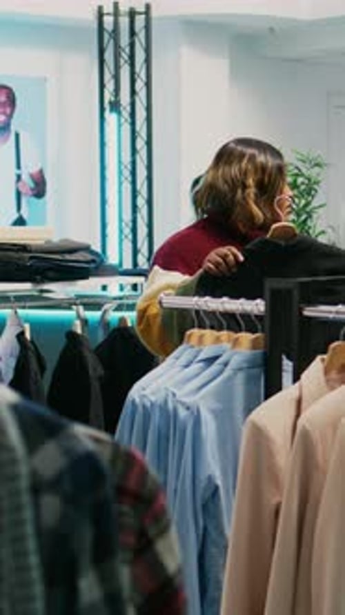 Vertical Video Store Assistant Helping African American Client with Clothes