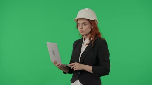 A Woman Architect Works on a Laptop Studies Plans Prints Reports Business Woman in a Protective