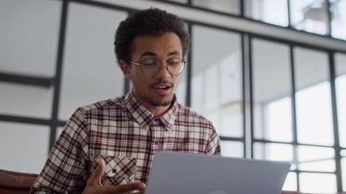 Young Man on Video Call in Modern Office
