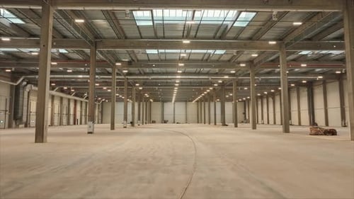Horizontal Shooting of Big Modern Lighted Industrial Space Logistics Warehouse Inside Footage of