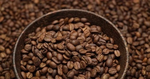 Roasted Coffee Beans Overflowing From Wooden Bowl