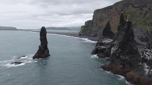 Aerial View of Iceland's Black Sand Beach and Coastal Cliffs