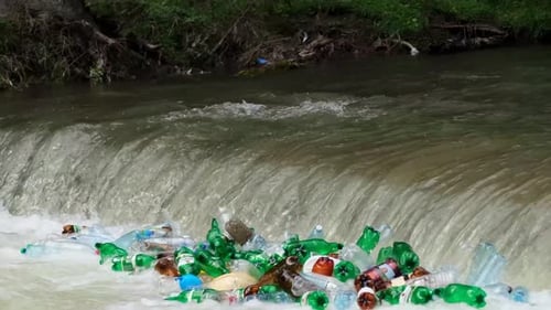 Plastic Bottles Piling Up in River Waterfall