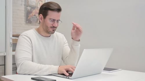 Adult Man Working on Laptop in Bright Office