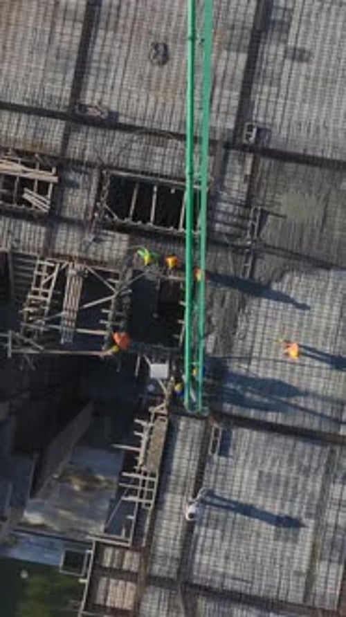 Vertical Video of Residential Construction With Metal Beams Concrete Foundations and Wall Assembly
