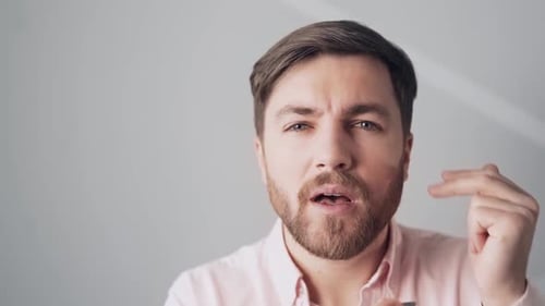 Man Using Tweezers to Pluck Eyebrows