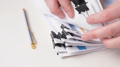 Businessman Hands Searching Information in Stack of Papers Files Financial Report on Work in Office