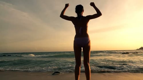 Happy Woman Jumping on Beach During Sunset Super 240