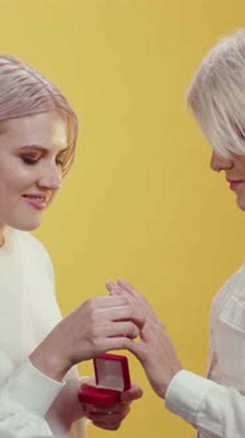 Woman Puts Engagement Ring on Another Woman's Finger