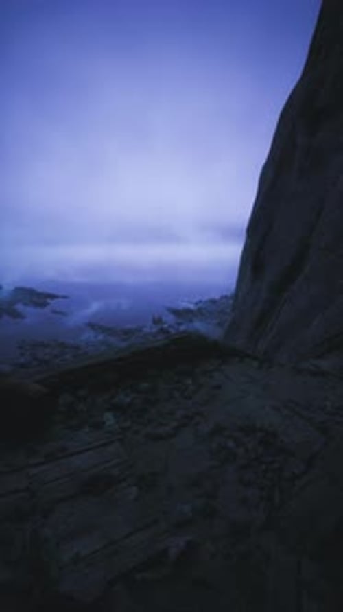 Mysterious Coastal Landscape Under Twilight Sky and Rocky Cliffs