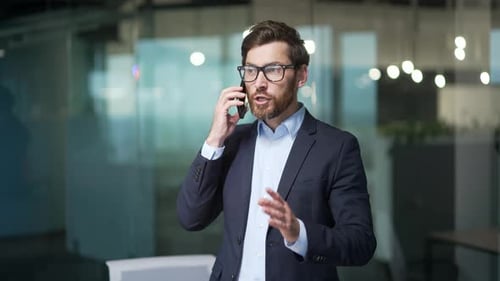 Irritated arguing business man boss yelling shouting in smartphone at office Angry nervous mature