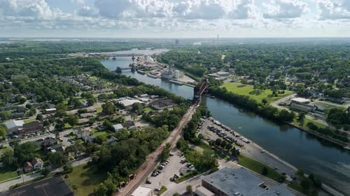 The Aerial View of a Town Divided By a Des Plaines River with a Bridge The Town with Lush Greenery a