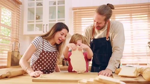 Caucasian attractive couple baking bakery with son in kitchen at home.