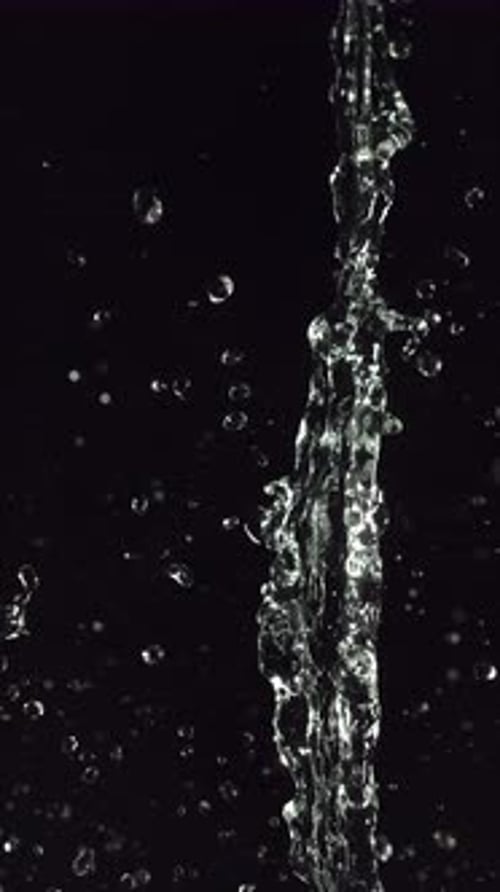 Clear Water Splash Against Black Background