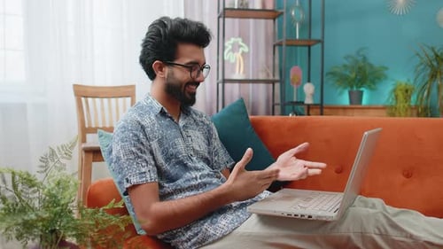 Young Adult on Laptop Having Video Call at Home