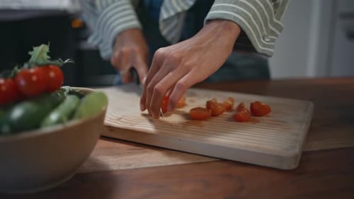 Woman Prepares Fresh Salad in Home Kitchen