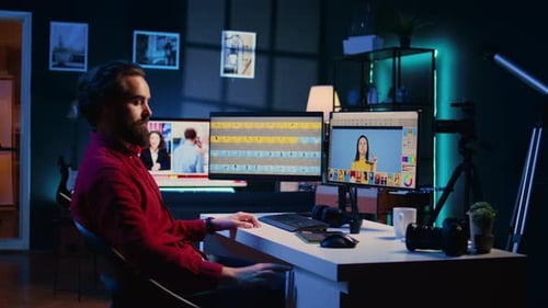 Video Editor Working at Computer at Night
